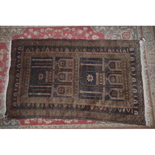 582 - A tribal prayer rug with architectural design in shades of red, blue, black and natural, 55