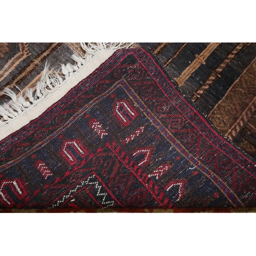 582 - A tribal prayer rug with architectural design in shades of red, blue, black and natural, 55