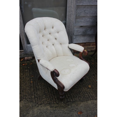 432 - A low armchair with circular seat, button and corded shell-shaped back, upholstered in a salmon broc... 