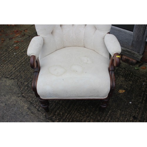 432 - A low armchair with circular seat, button and corded shell-shaped back, upholstered in a salmon broc... 