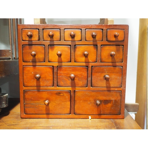 109 - A miniature oriental hardwood chest of fourteen graduated drawers, 15