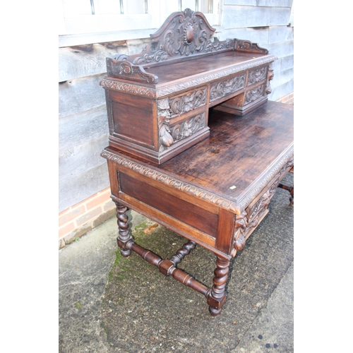 415 - A late 19th century carved oak desk, the upper gallery fitted five drawers over five further drawers... 