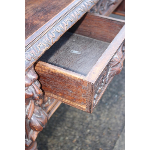 415 - A late 19th century carved oak desk, the upper gallery fitted five drawers over five further drawers... 