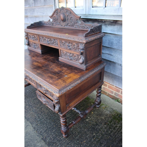 415 - A late 19th century carved oak desk, the upper gallery fitted five drawers over five further drawers... 