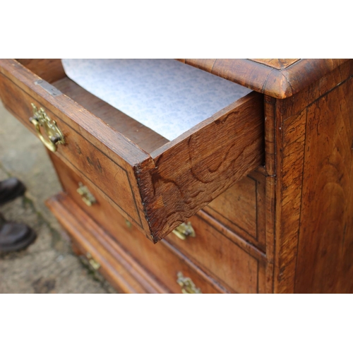 443 - An early 18th century figured walnut and banded chest on stand, the upper section fitted two small d... 