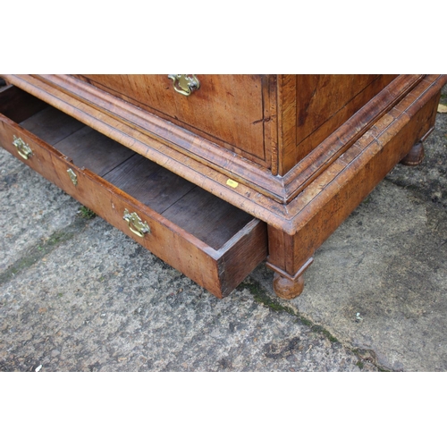 443 - An early 18th century figured walnut and banded chest on stand, the upper section fitted two small d... 