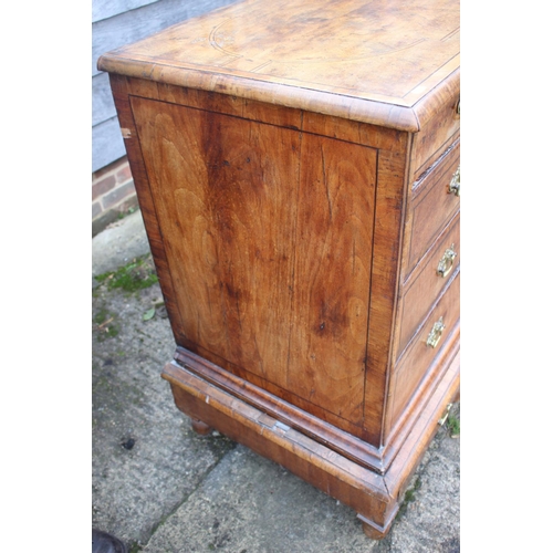 443 - An early 18th century figured walnut and banded chest on stand, the upper section fitted two small d... 