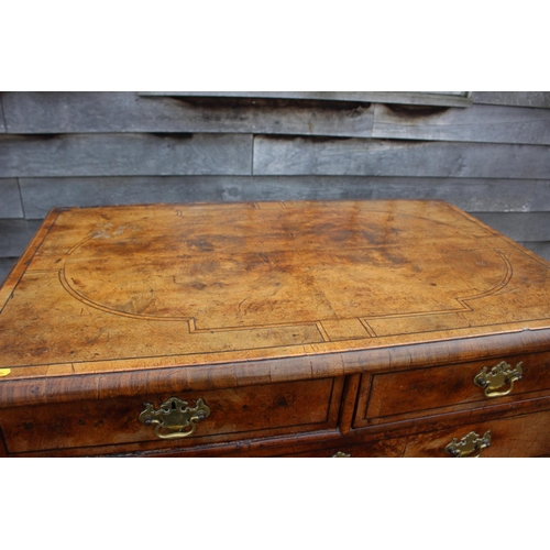 443 - An early 18th century figured walnut and banded chest on stand, the upper section fitted two small d... 