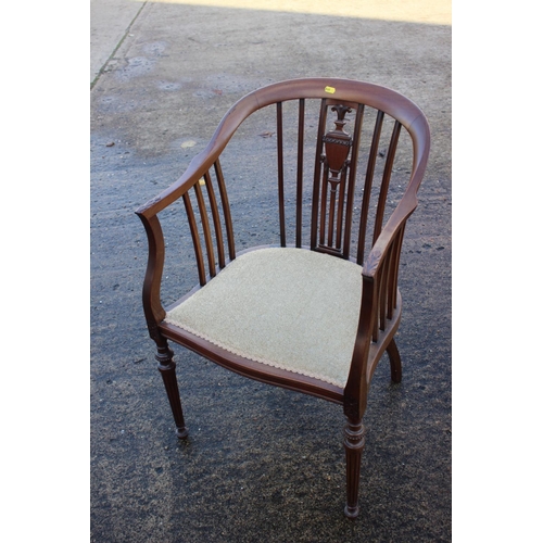 464 - An Edwardian walnut carved vase splat back tub elbow chair with padded seat, on turned supports