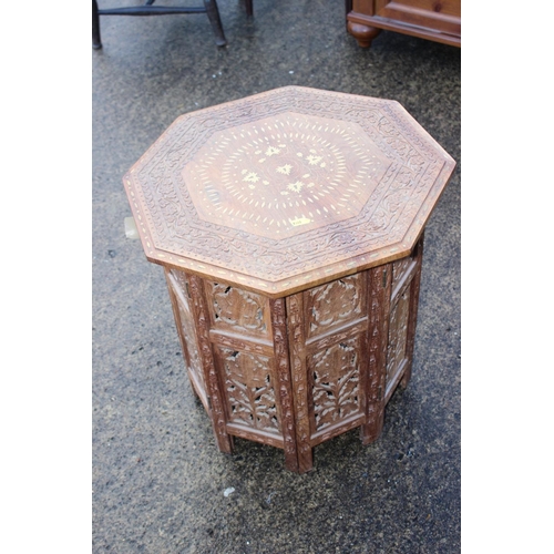 469 - A Kashmir carved and brass inlaid hardwood octagonal occasional table, on folding support, 18