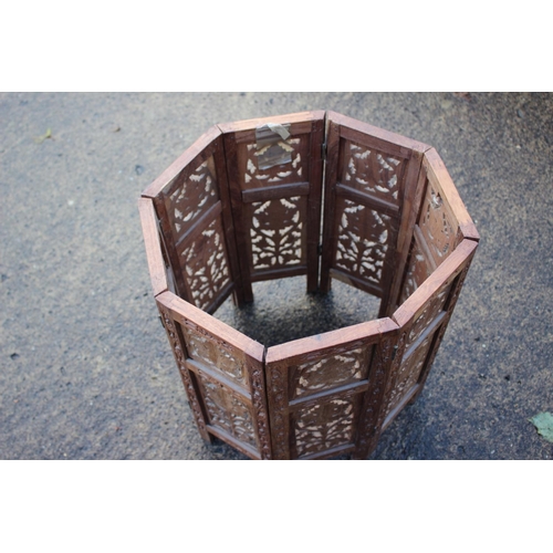 469 - A Kashmir carved and brass inlaid hardwood octagonal occasional table, on folding support, 18