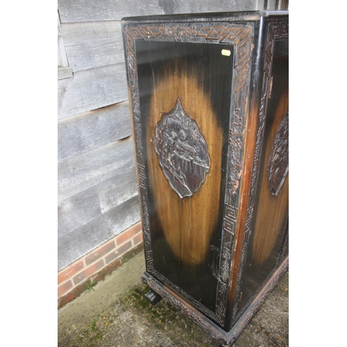 474 - A 1930s Chinese carved hardwood wardrobe enclosed two doors, on shaped supports, 36