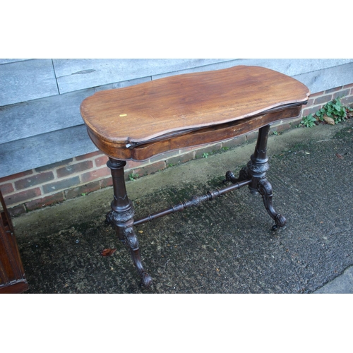 481 - A walnut shaped fold-over top card table, on carved turned and stretchered supports, 37