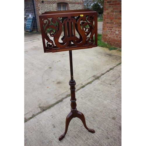 508 - A reproduction mahogany music stand, on tripod splay support