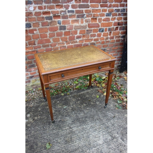 510 - An Edwardian walnut writing table with tooled lined top, fitted one drawer, on square taper supports... 