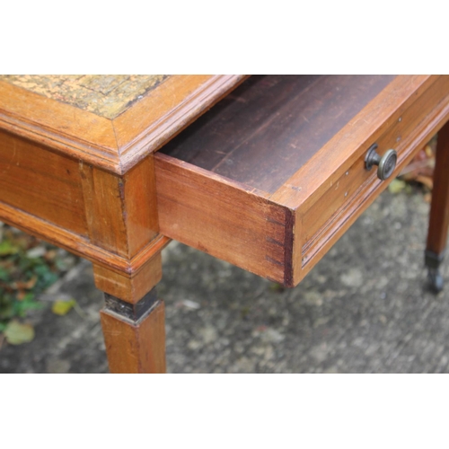 510 - An Edwardian walnut writing table with tooled lined top, fitted one drawer, on square taper supports... 