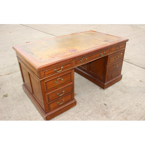 512 - A mid 20th century walnut double pedestal desk with tooled lined top, fitted nine drawers, on block ... 