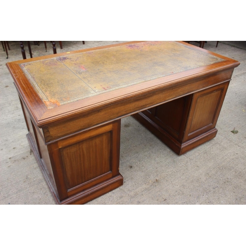 512 - A mid 20th century walnut double pedestal desk with tooled lined top, fitted nine drawers, on block ... 