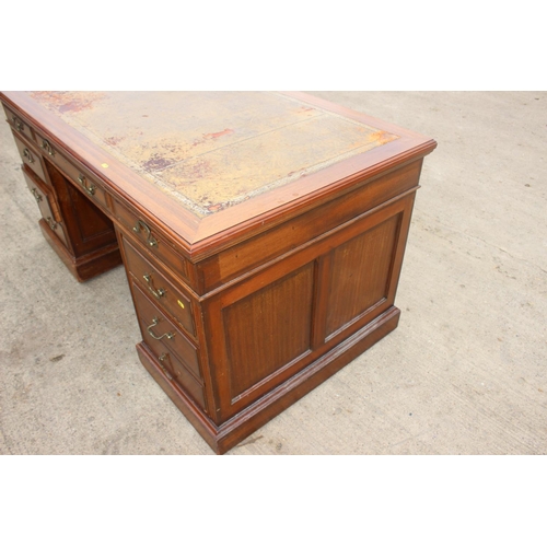 512 - A mid 20th century walnut double pedestal desk with tooled lined top, fitted nine drawers, on block ... 