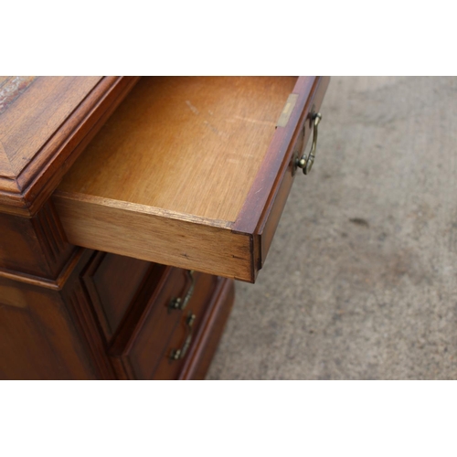 512 - A mid 20th century walnut double pedestal desk with tooled lined top, fitted nine drawers, on block ... 