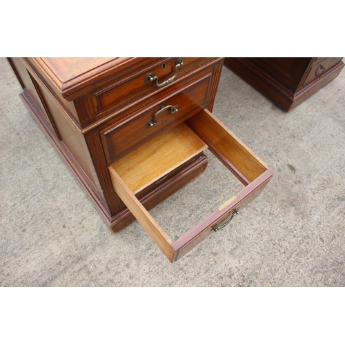 512 - A mid 20th century walnut double pedestal desk with tooled lined top, fitted nine drawers, on block ... 