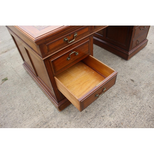 512 - A mid 20th century walnut double pedestal desk with tooled lined top, fitted nine drawers, on block ... 