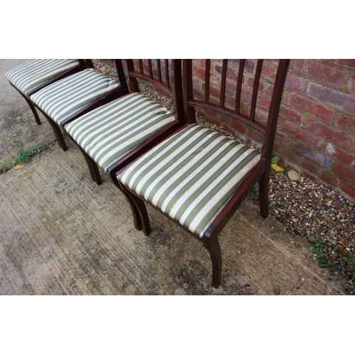 515 - A set of four reproduction mahogany side chairs with drop-in seats and a carver chair with striped d... 