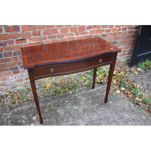 519 - A mahogany and banded serpentine side table, fitted two drawers, 33