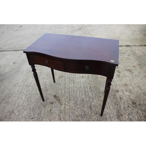 519 - A mahogany and banded serpentine side table, fitted two drawers, 33