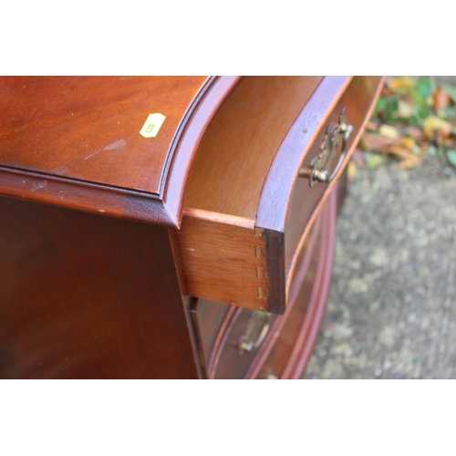 522 - A reproduction walnut serpentine front shallow chest of four drawers, 31