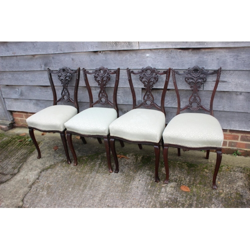 552 - An Edwardian salon suite with pierced ebonised splay backs, on cabriole supports, comprising four ch... 