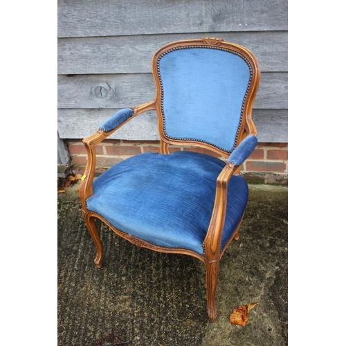 559 - A polished as walnut open armchair of Louis XVI design, upholstered in a blue velour, on cabriole su... 