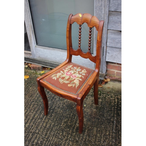 560 - A French walnut side chair with bobbin spindle back and tapestry seat, on cabriole supports