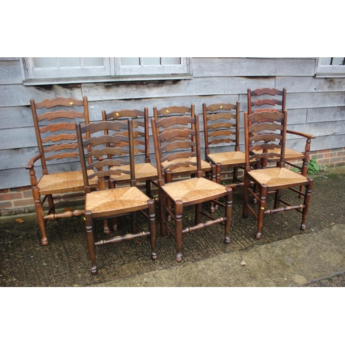 562 - A set of eight ash and oak ladder back dining chairs with rush envelope seats, on turned and stretch... 