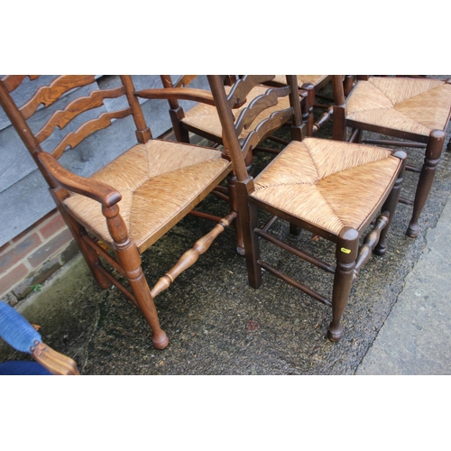 562 - A set of eight ash and oak ladder back dining chairs with rush envelope seats, on turned and stretch... 