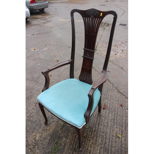 563 - An Edwardian carved mahogany high back elbow chair with pierced wheatsheaf back and padded seat, on ... 