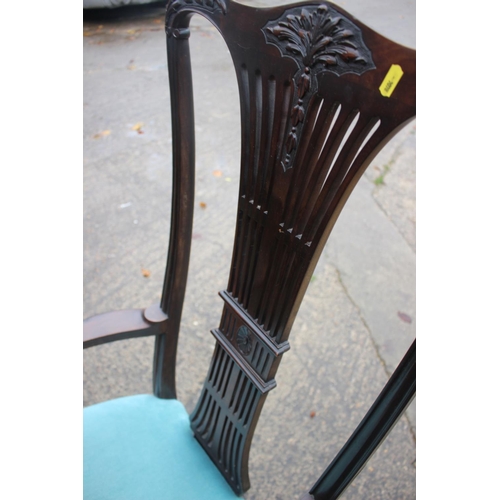 563 - An Edwardian carved mahogany high back elbow chair with pierced wheatsheaf back and padded seat, on ... 