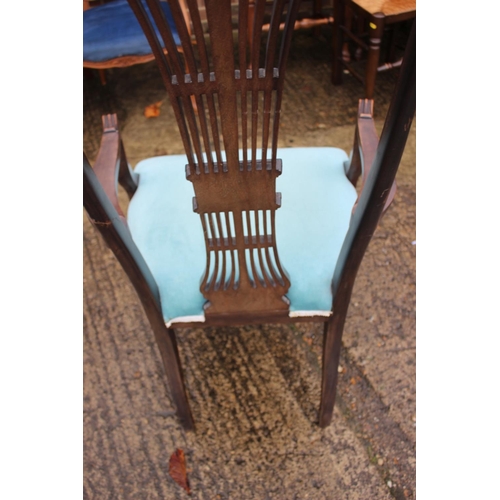 563 - An Edwardian carved mahogany high back elbow chair with pierced wheatsheaf back and padded seat, on ... 