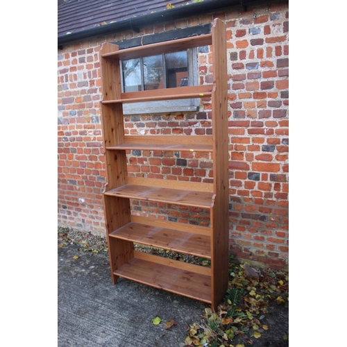 566 - A stripped pine waterfall bookcase with six shelves, 36 1/2