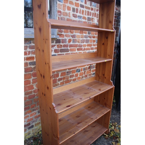 566 - A stripped pine waterfall bookcase with six shelves, 36 1/2