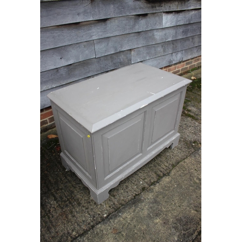 568 - A grey painted pine panel front blanket box, on bracket feet, 38