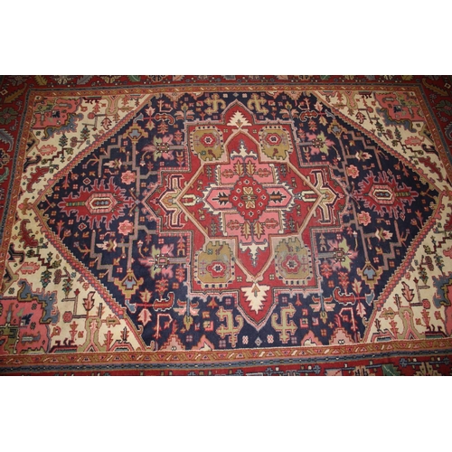 572 - A Caucasian wool rug with central medallion on a blue ground, geometric and floral designs and multi... 