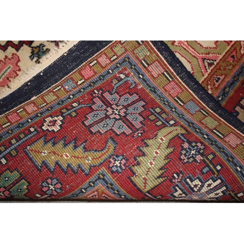 572 - A Caucasian wool rug with central medallion on a blue ground, geometric and floral designs and multi... 