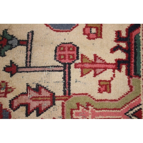 572 - A Caucasian wool rug with central medallion on a blue ground, geometric and floral designs and multi... 