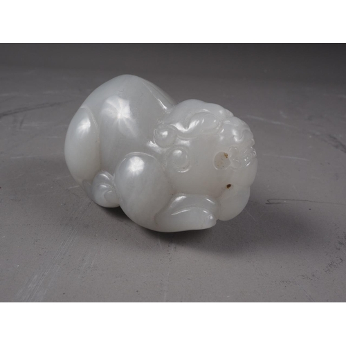 67 - A Chinese carved pale jade model of a mythical beast, 2 3/4