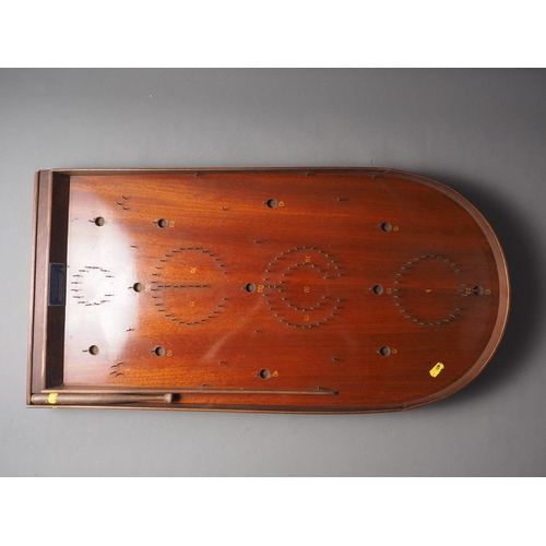 123 - An early 20th century mahogany Holey Bogey Corinthian Bagatelle board with ball bearings and push st... 