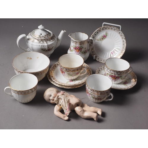 130 - A 1920s Nippon porcelain headed composition doll and a doll's teaset