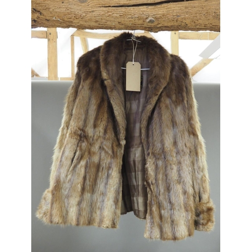 141 - A fur coat, a similar fur cape, various designer style handbags, a leather travelling suitcase, all ... 