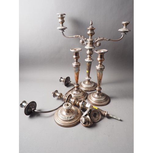 245 - A pair of silver plated three-light candelabra and two similar single-light candlesticks