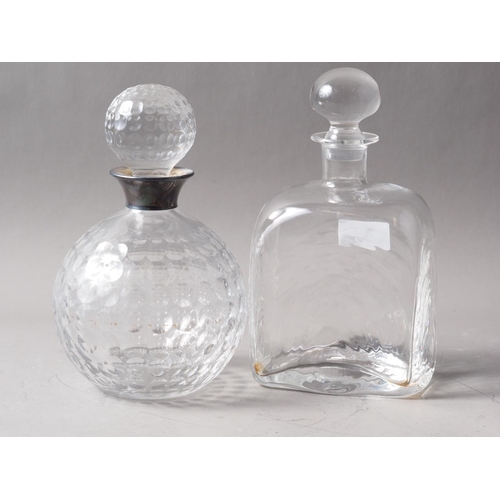 254 - A silver collared glass golf ball effect decanter and stopper and another decanter